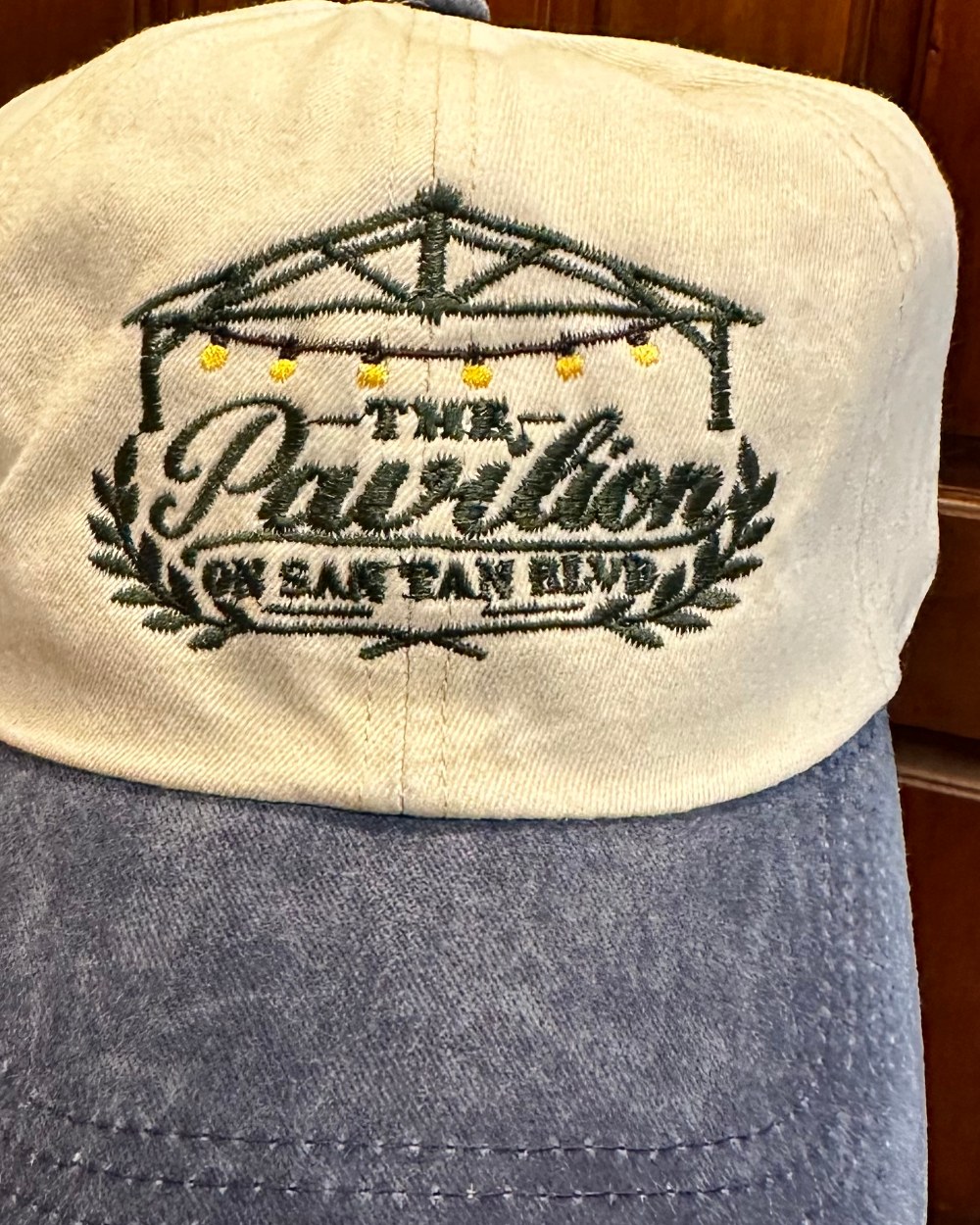 Four cream and denim caps embroidered with the LaShaw Century Farm logo